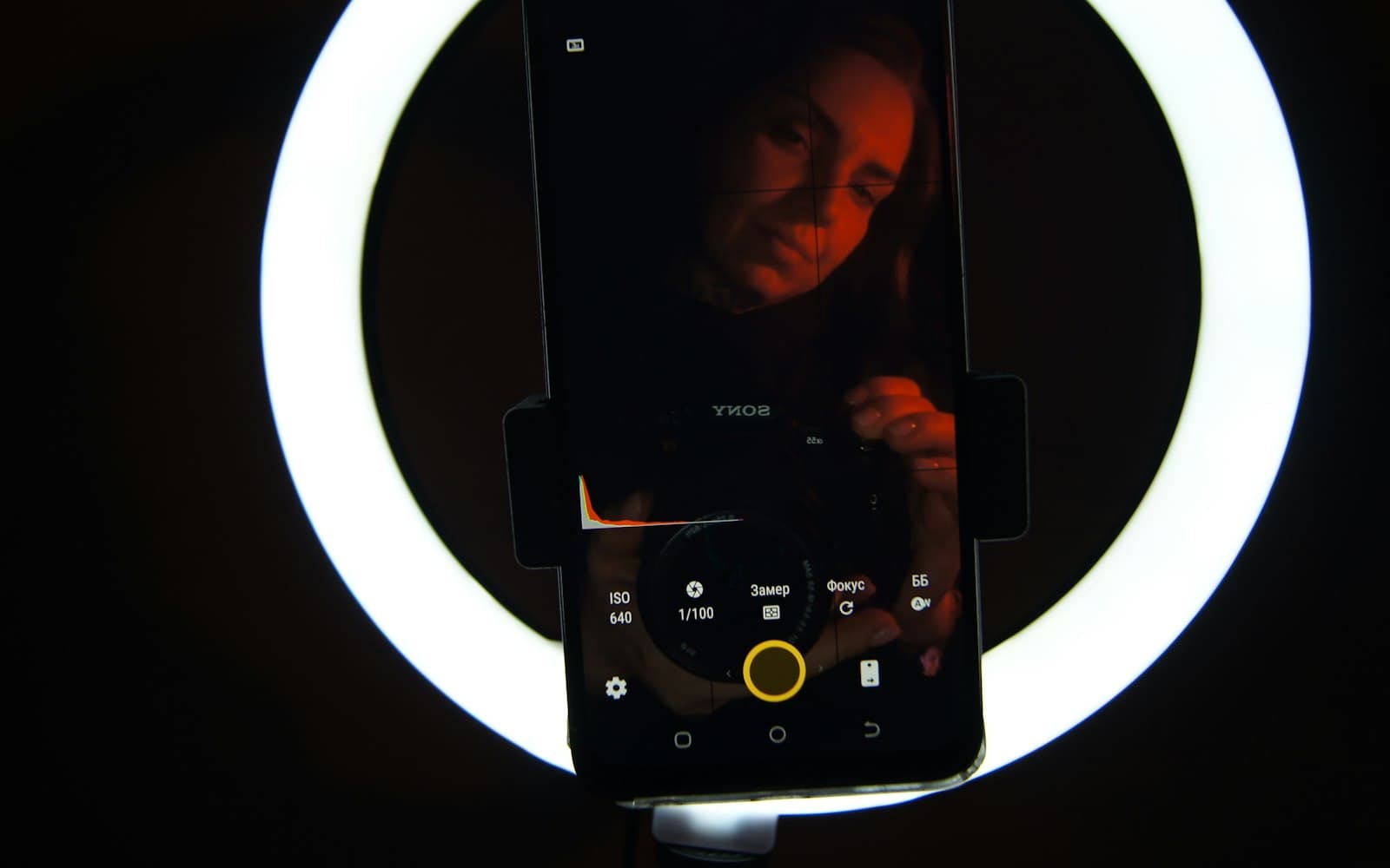 A smartphone in front of a glowing ring light