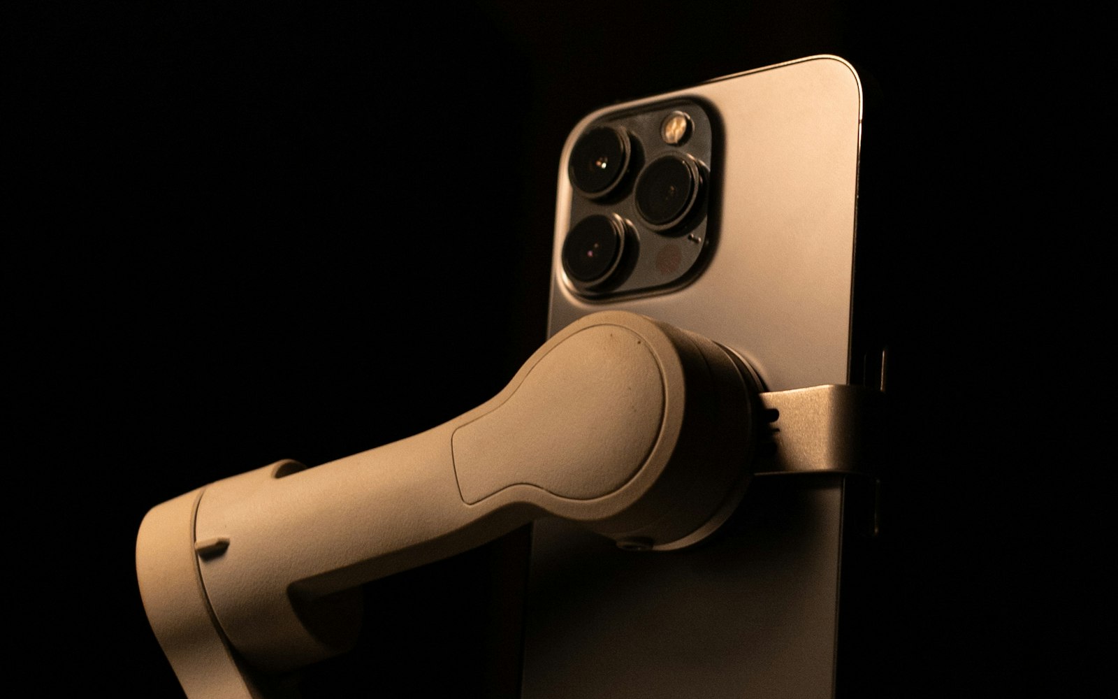 A smartphone held vertically in a handheld gimbal